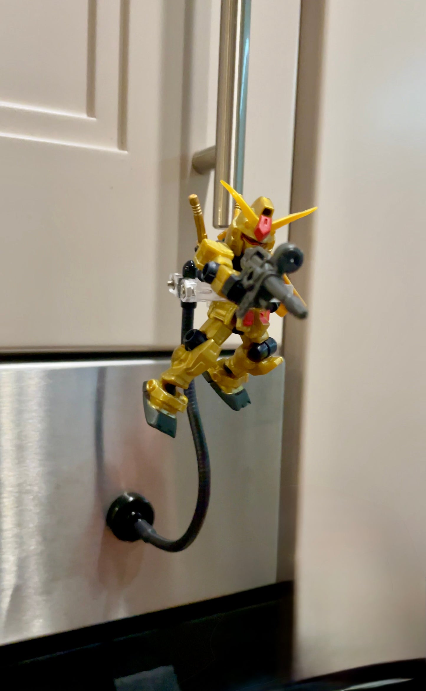 Mobile Suit Ensemble Gundam on a magnetic stand attached to an oven
