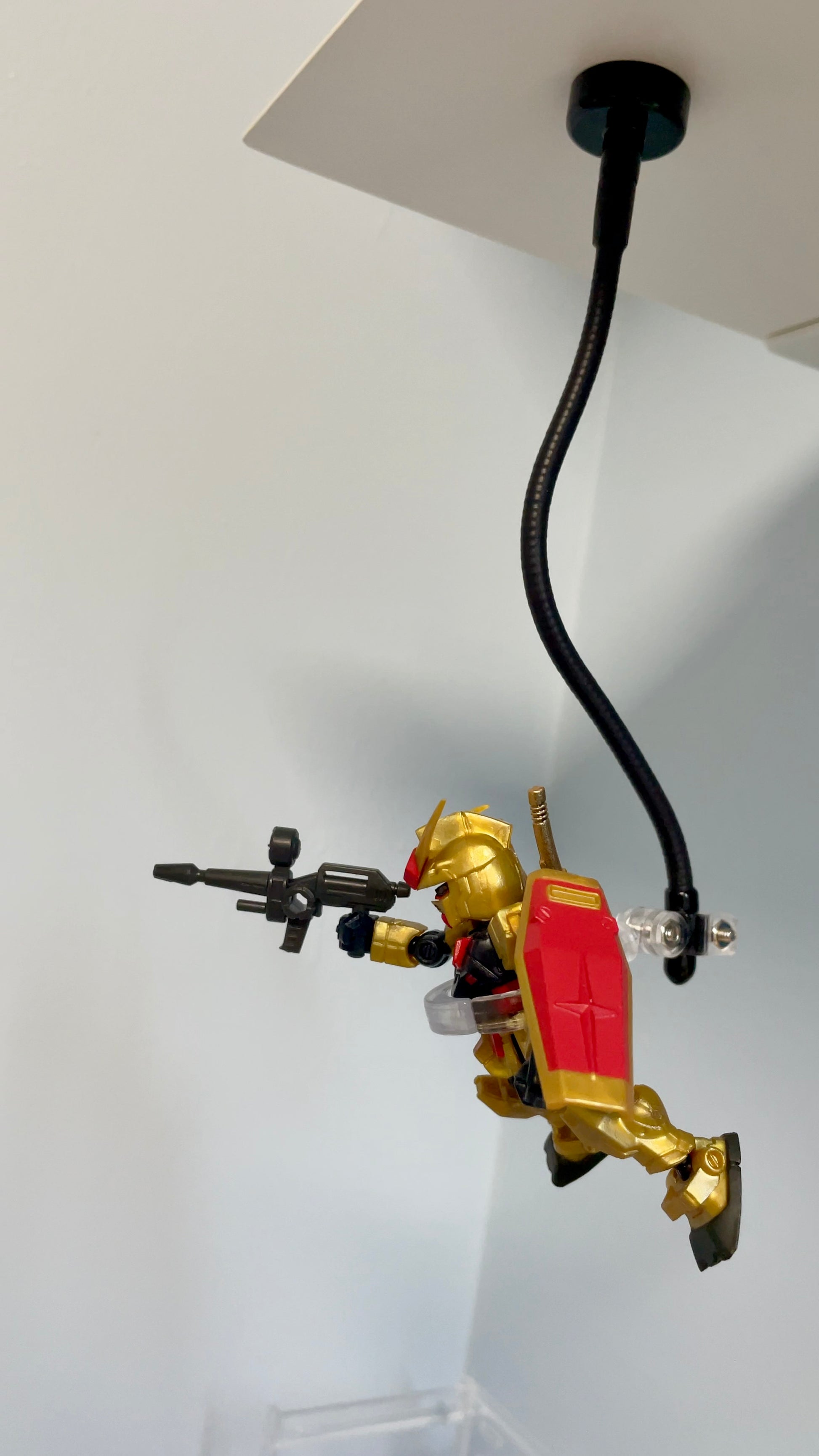 Mobile Suit Ensemble Gundam on magnetic stand attached under a metal shelf